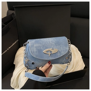 Detail of light blue denim shoulder bag with silver hardware and metallic chain strap