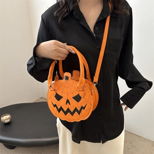Fashionable Halloween orange pumpkin shoulder bag with a black jack-o'-lantern face detail
