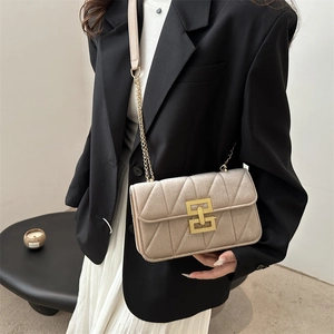 Elegant champagne quilted crossbody bag with gold geometric buckle and chain strap