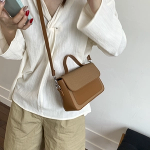 Chic 2025 brown woven crossbody bag for women with elegant leather texture and top handle
