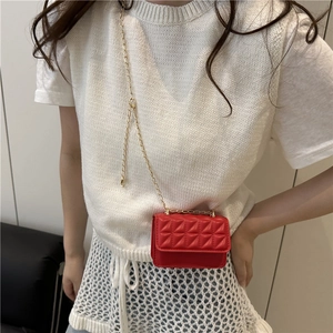 Fashionable red quilted mini crossbody bag with golden chain strap worn by a model