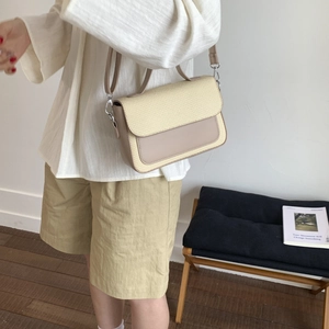 Minimalist straw textured crossbody bag in cream and light brown with shoulder strap