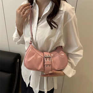 Pink patent leather crescent shoulder bag with vintage buckle and pleated design