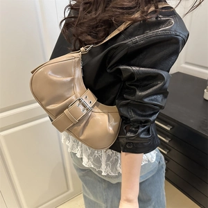 Chic apricot crescent shoulder bag with glossy patent leather and wide belt buckle accent