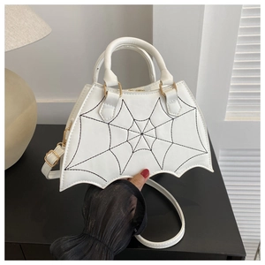 Detailed view of white bat wing gothic handbag with black cobweb stitching and PU leather texture
