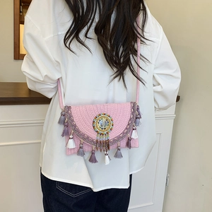 Pink woven bohemian crossbody bag with colorful bead mandala and fringe tassel accents