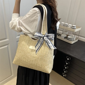 Large woven straw shoulder bag with blue striped silk scarf and leather logo patch