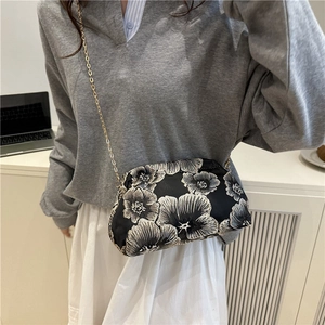 Elegant black crossbody bag with floral embroidery and gold chain strap for women