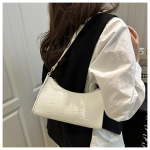 Close-up of white crocodile pattern shoulder bag with sleek zip closure and PU leather texture