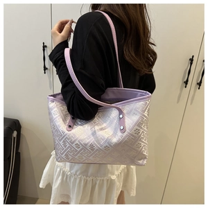 Detail of light purple large tote bag featuring geometric jacquard fabric and leather straps