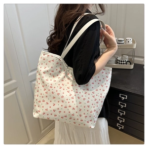 Shoulder tote bag featuring cherry print pattern on a cream background for daily commute