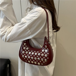 Fashionable burgundy crescent dumpling bag with silver rivets and sleek shoulder strap