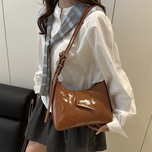 Chic brown patent leather shoulder bag for women with unique gold buckle and vintage style