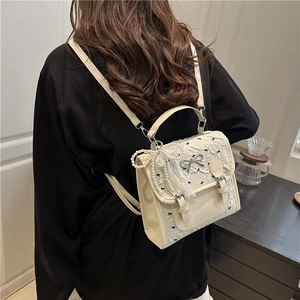 Sweet cream mini backpack with lace overlay, black bows and elegant pearl chain accessory