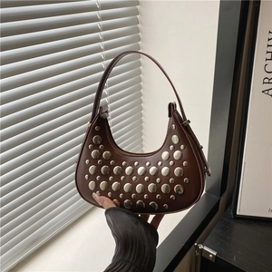 Dark brown leather hobo bag with silver metal rivets and minimalist crescent shape