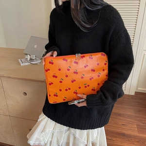 Vibrant orange 13-14 inch laptop sleeve with cherry print and dual metal zippers