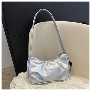 Detail view of silver pleated shoulder bag with FASHION & BAG metallic logo plaque