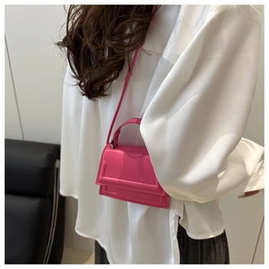 Mini rose pink crossbody bag with rectangle stitching shown on a person wearing white shirt