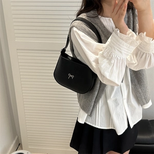 Minimalist black leather hobo bag with silver metallic bow detail for women