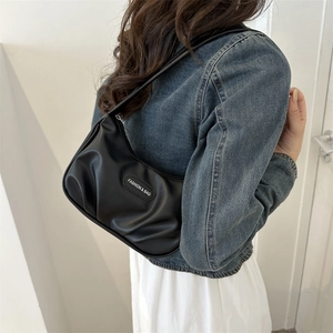 Chic black pleated crescent hobo bag with adjustable shoulder strap and fashion label
