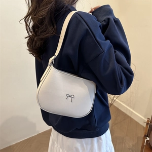Minimalist white faux leather shoulder bag with a silver metal bow accent for women