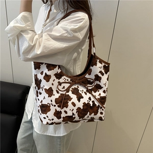 Minimalist cow print tote bag with bow detail and large capacity shoulder straps