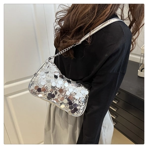 Silver sequin shoulder bag detail featuring large round sequins and metal chain strap