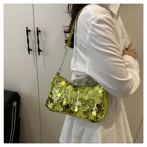 Detail of lime green sequin shoulder bag with large round scales and chain strap