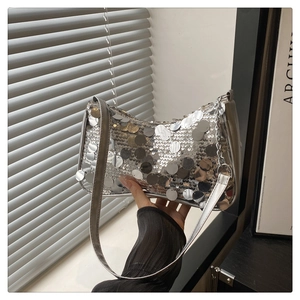 Macro shot of silver sequins and side chain detail on this stylish dumpling bag