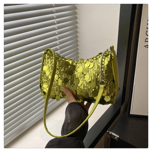 Detailed close-up of emerald green sequin shoulder bag with silver decorative chain