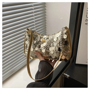 Close-up of sparkling silver and gold sequins on a leather trim shoulder bag