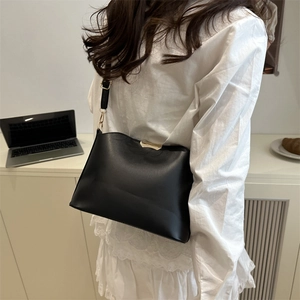 Chic black faux leather crossbody bag with gold metal buckle and leather strap