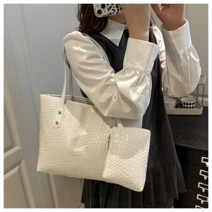 Detail of white woven leather tote set including large handbag and matching pouch