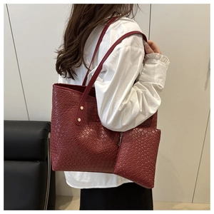 Detail of burgundy woven tote bag and matching zippered pouch for daily commute