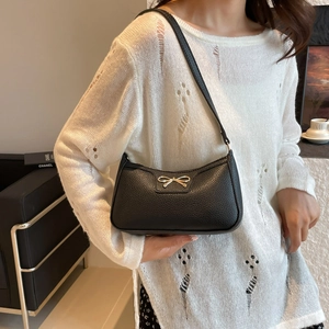 Chic black litchi pattern baguette shoulder bag with gold bow knot accessory
