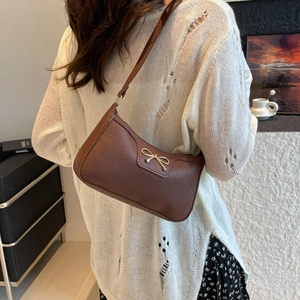 Brown baguette shoulder bag with a gold bow and lychee pattern leather for women