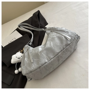 Detail of grey marble texture leather bag with silver double zippers and cloud charm
