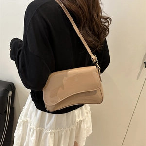Minimalist beige patent leather square bag with asymmetrical flap and gold hardware strap