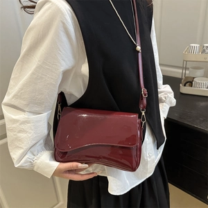 Deep red patent leather crossbody bag for women with minimalist rectangular flap design