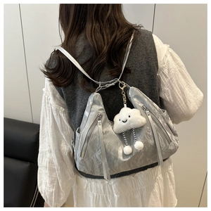 Rear view of model wearing a silver pleated hobo bag with dual zippers and cloud charm
