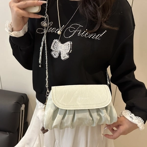 Mint green pleated crossbody bag with silver chain strap and fashion logo print
