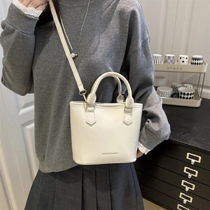Minimalist white bucket bag with 'FASHION & BAGS' text for handheld or crossbody wear