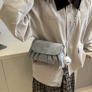Silver pleated chain crossbody bag for women with a cute plush monster keychain charm