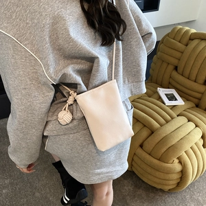 Minimalist beige crossbody phone bag with litchi grain texture and woven knot detail