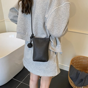 Minimalist black lychee texture mini phone crossbody bag with stylish knot strap detail
