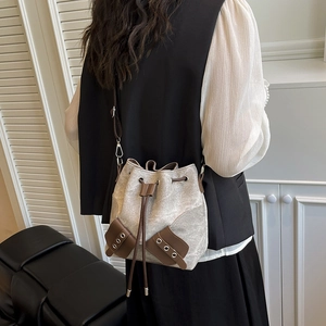 Minimalist canvas bucket bag with leather trim and drawstring closure for women