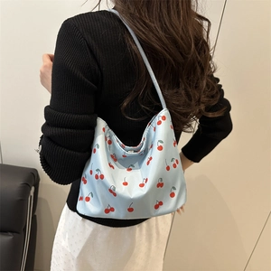 Light blue bucket bag with red cherry print featuring a U-shaped design for women