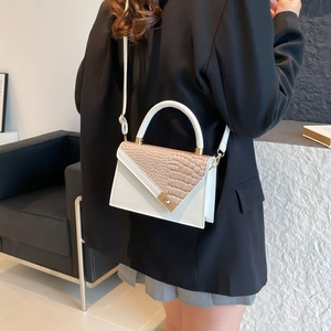 Minimalist white leather crossbody bag with brown croc-pattern flap and metal lock