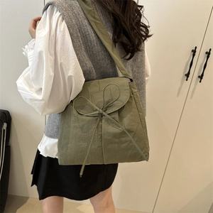Olive green nylon tote crossbody bag with decorative bow and pleated texture