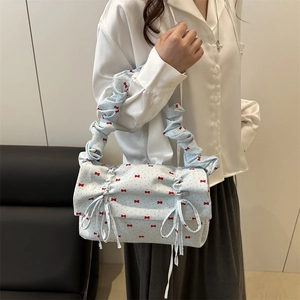 Light blue shoulder bag with red bow pattern and ruffled handle for women